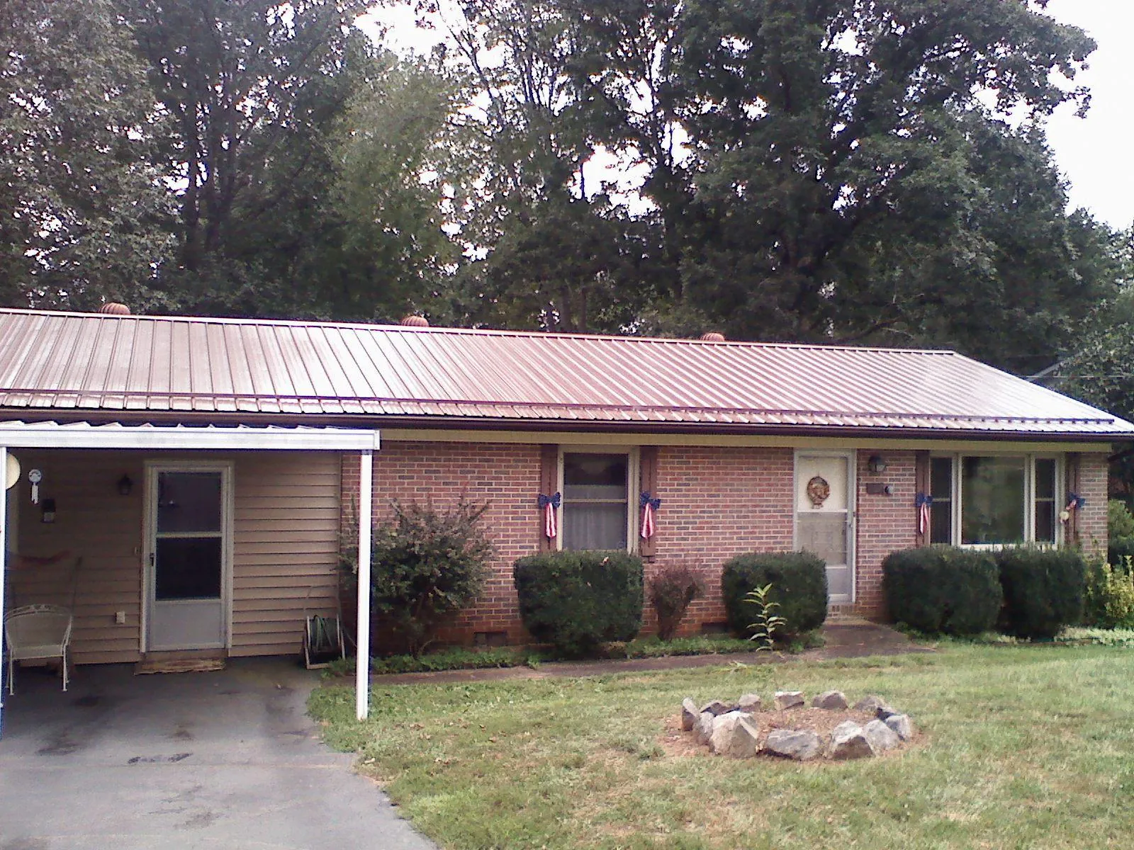 Bronze metal roof and carport on a brick ranch home — Roof Repair work by our crew in Scotland